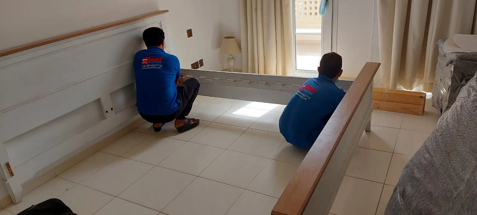ARZ Movers carpenter assembling bedroom furniture in a Dubai home