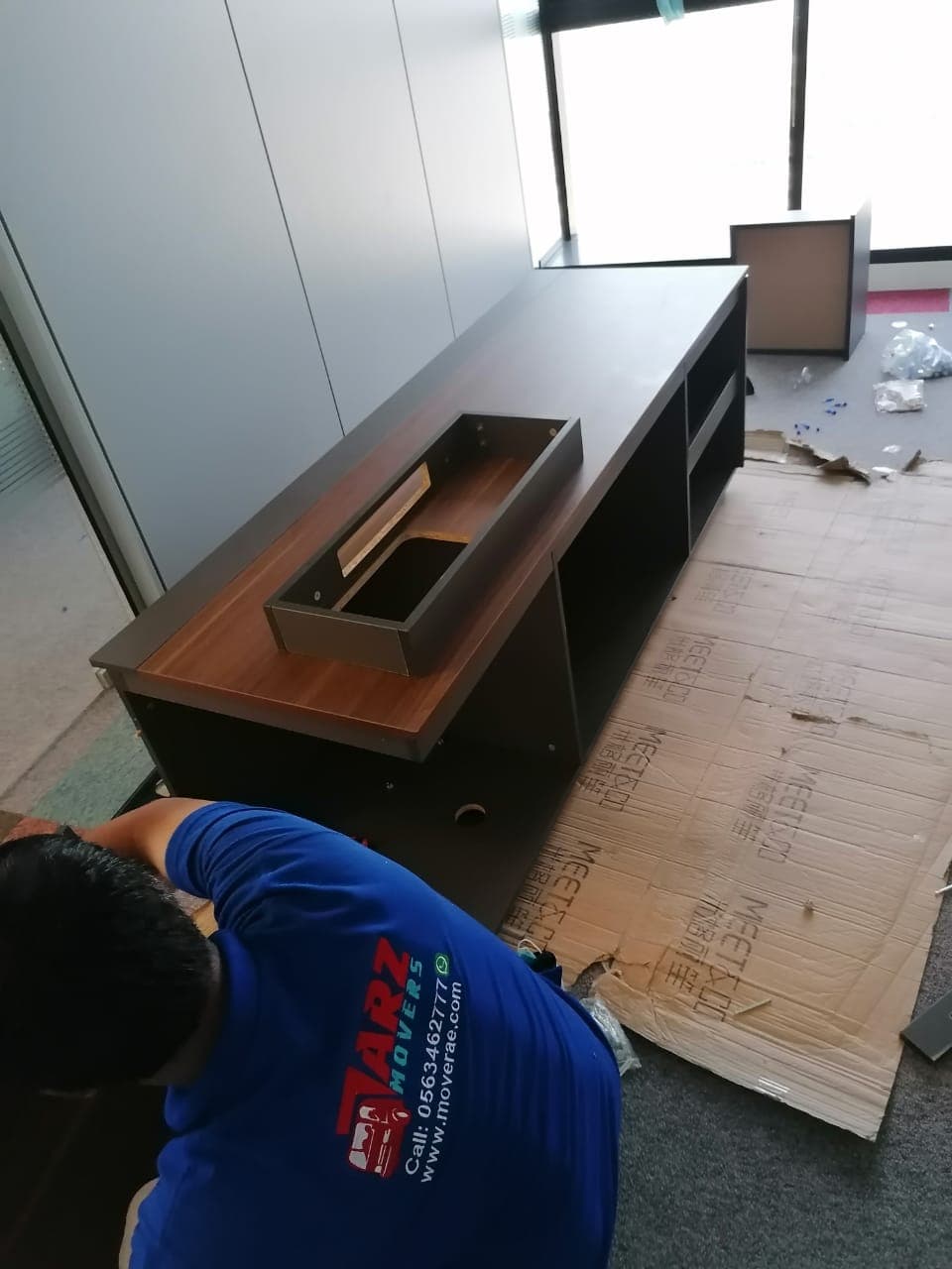 ARZ Movers technician assembling a custom executive desk in a Dubai office