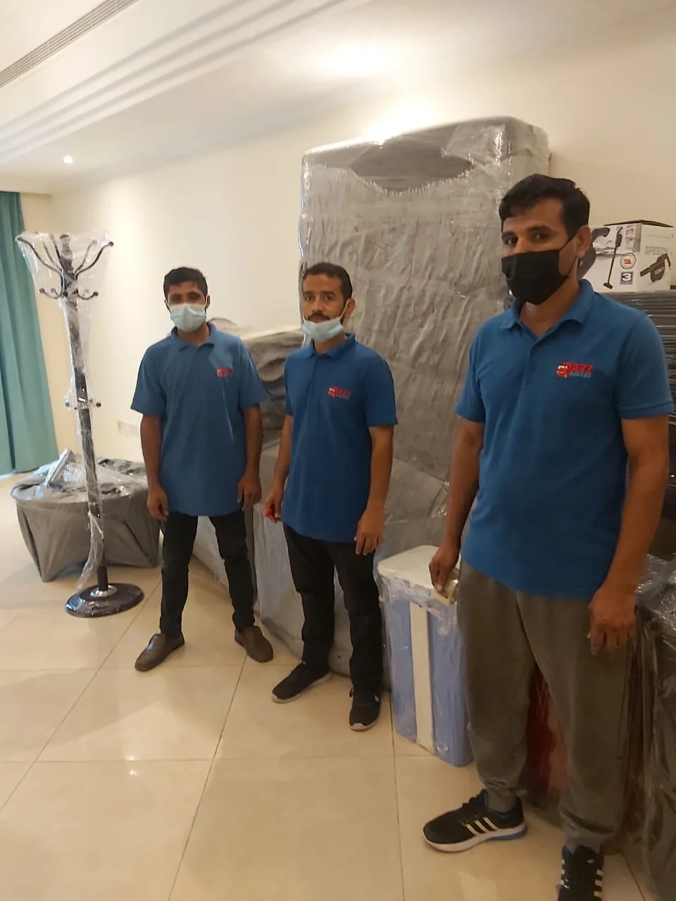 ARZ Movers crew with wrapped villa furniture ready to load